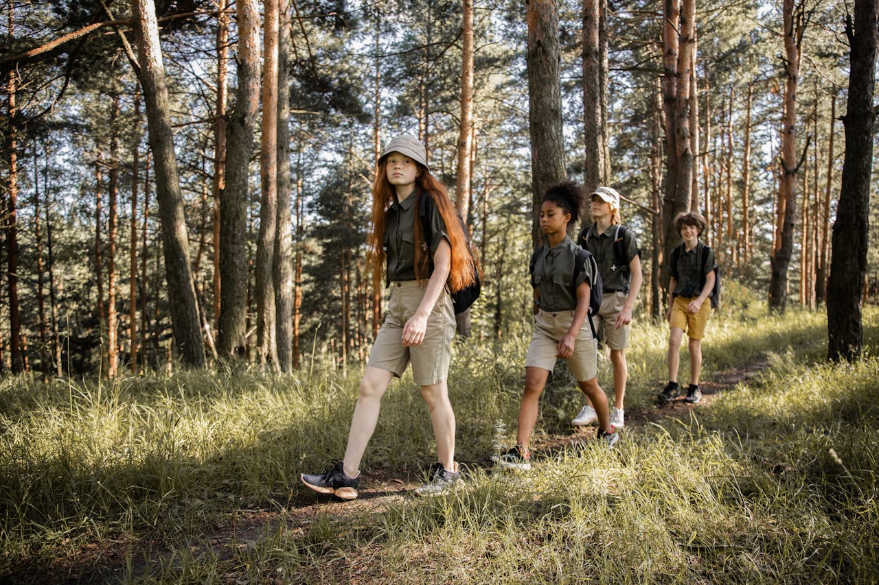 about-01 Group of teenagers hiking through a forest trail, enjoying nature and exploration.
