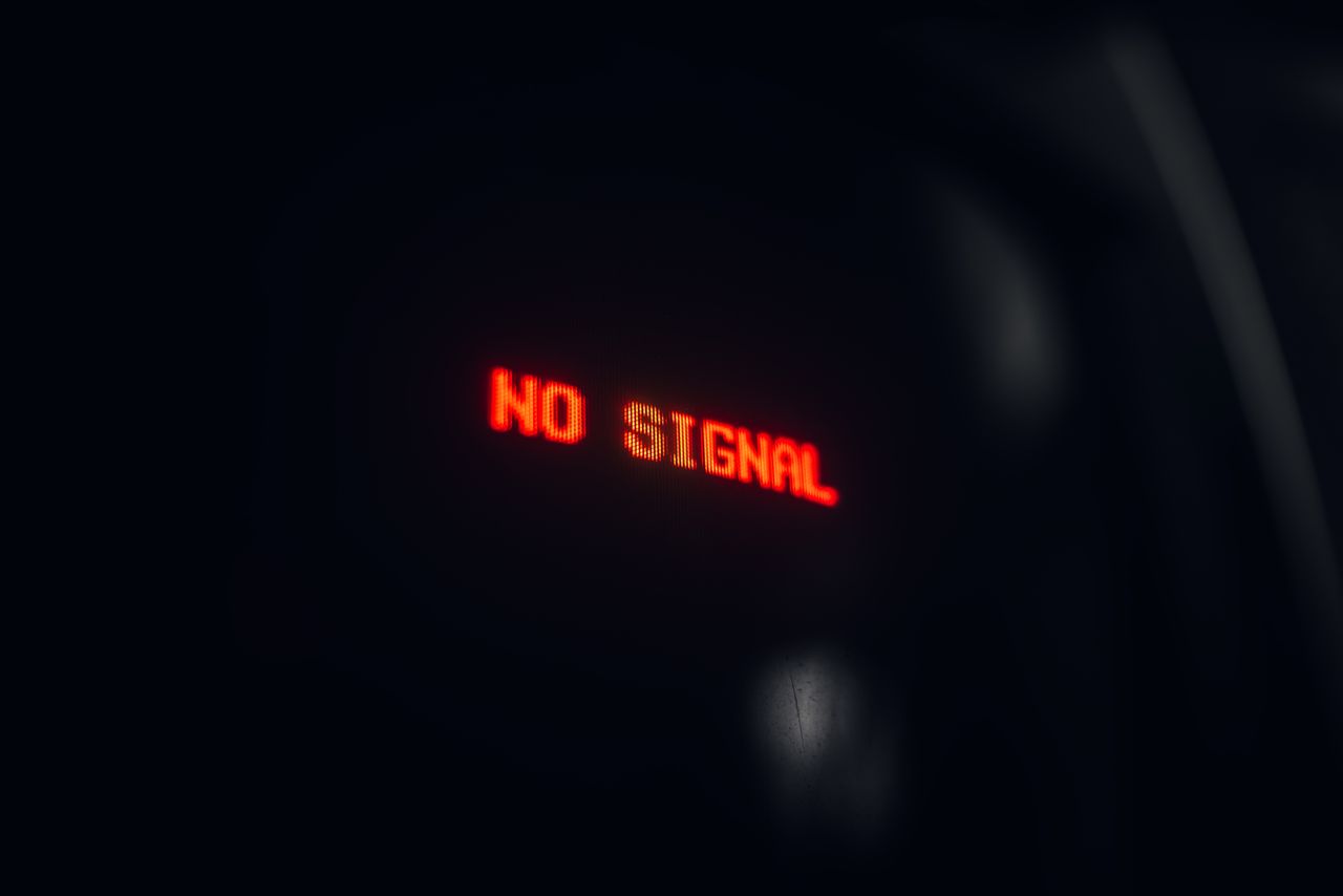 gallery-1 A red LED display indicating 'No Signal' in a dark setting, conveying a tech warning.